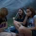 Natasha Wallace (right) laughs with Morgan and Megan Ploegstra under a poncho as it begins to rain at the Ann Arbor Summer Festival on Sunday, July 7. Daniel Brenner I AnnArbor.com